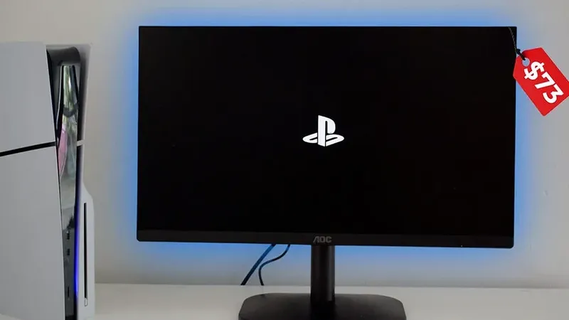 Monitor AOC de 73$ conectado a PS5 mostrando logo de PlayStation en pantalla negra con retroiluminación azul.