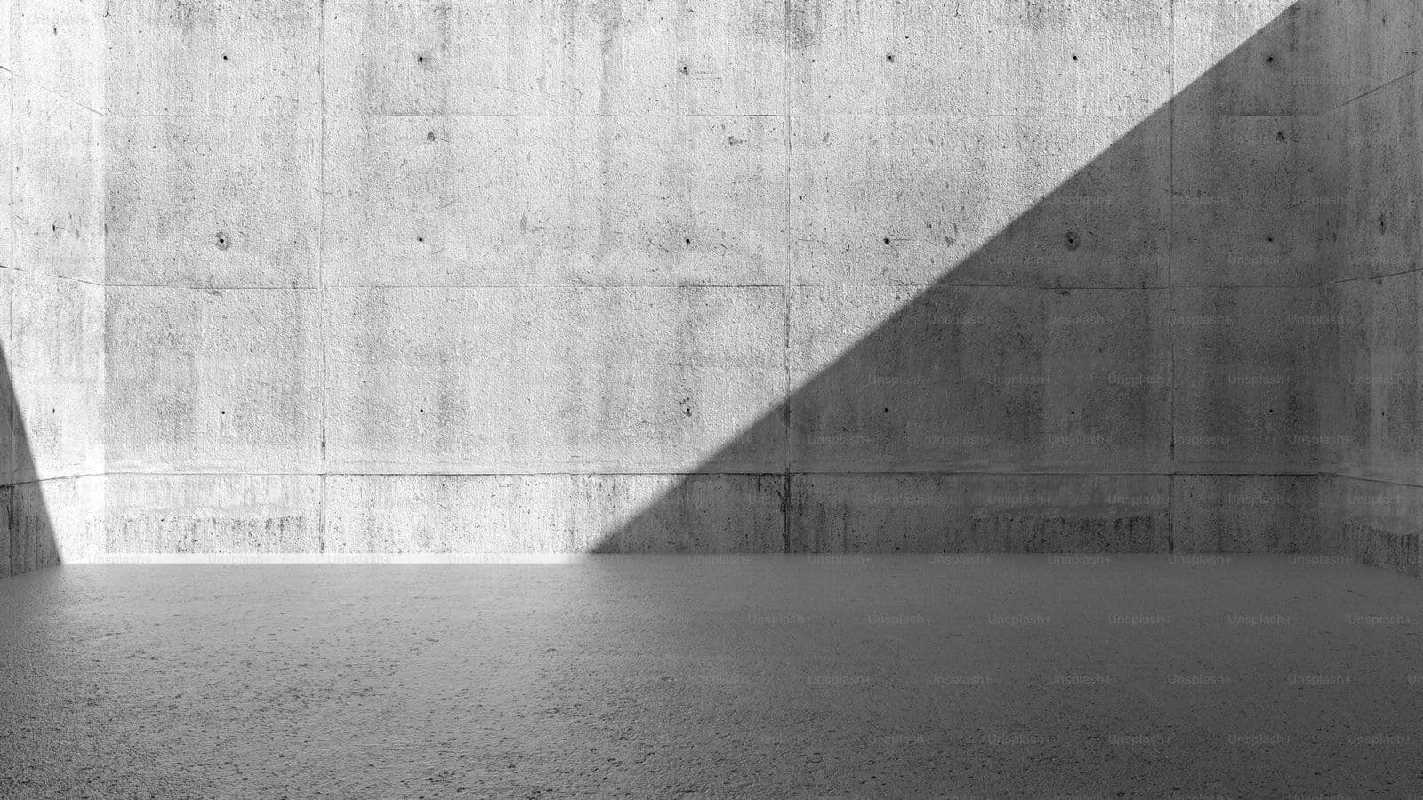 Sala vacía de hormigón con luz diagonal dramática, estética minimalista brutalista en blanco y negro
